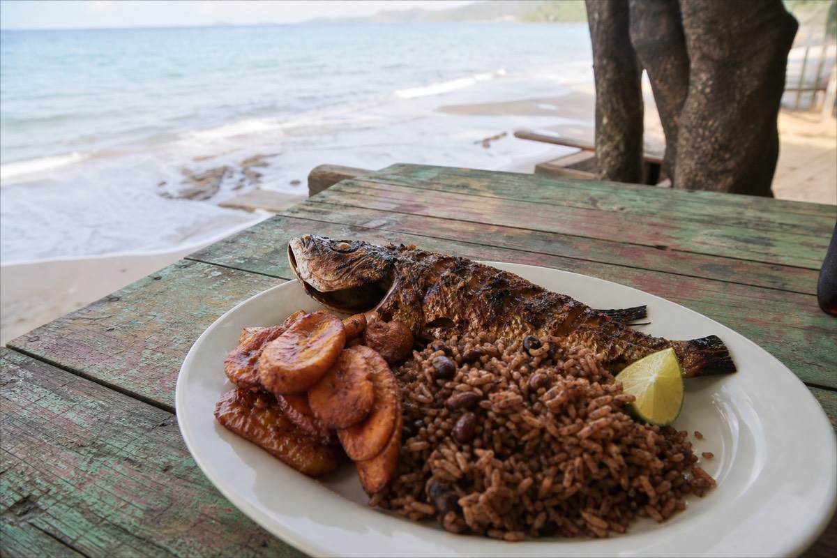 Grilled fish with plantain at a beachside spot